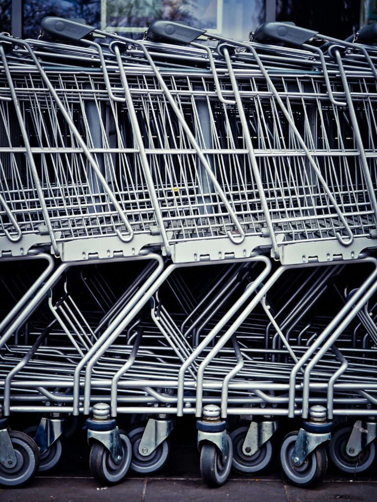 Rows of stacked metal shopping carts forming a repetitive industrial pattern.